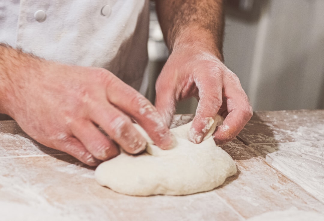 Hands of a baker making bread